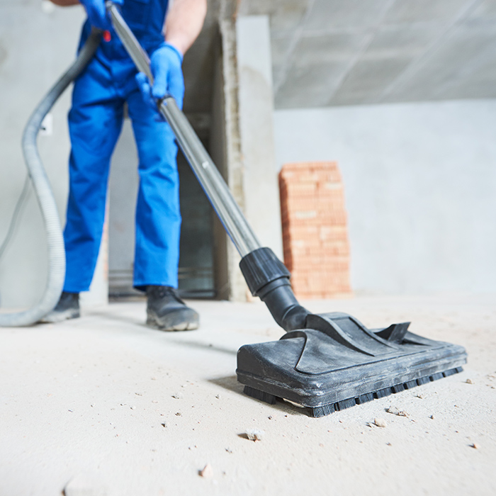 contractor close up removing dust from construction site with vacuum cleaner madison wi